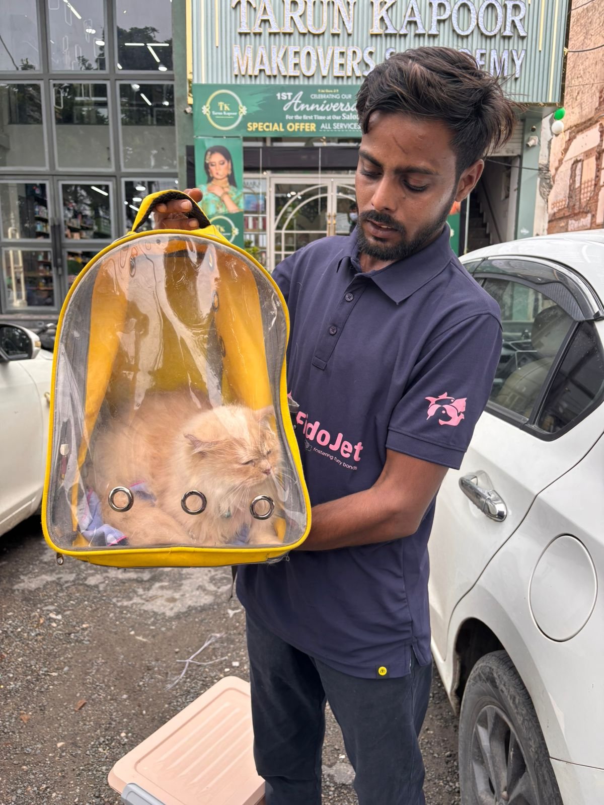 A FidoJet handler carrying a cat safely in a travel carrier